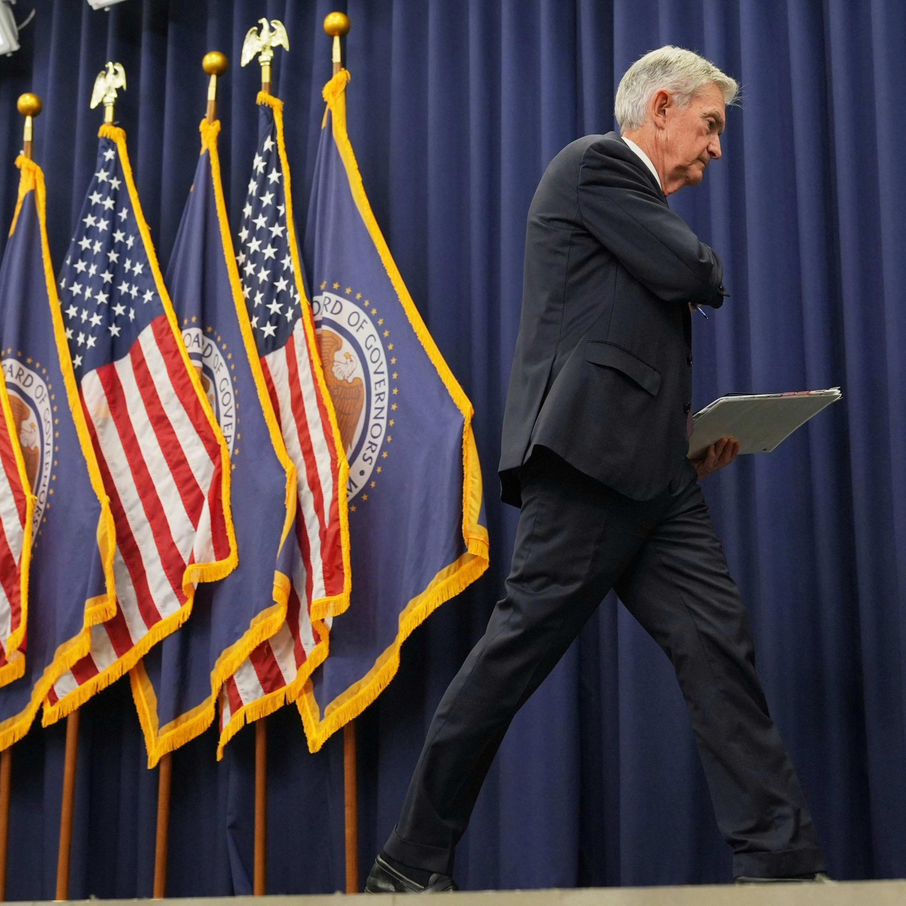 Fed Cuts Rates, Warns of Economic Risks