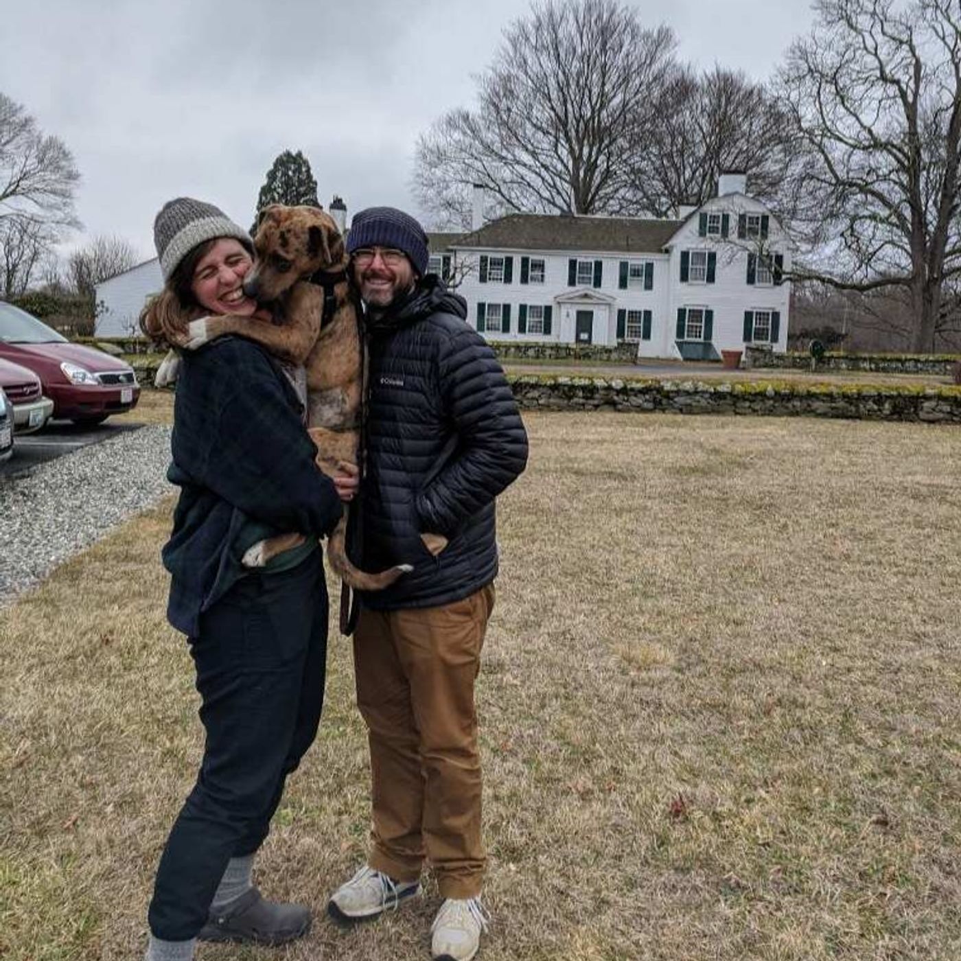 Rachel Playe and Peter Salomone laugh with Maggie the dog